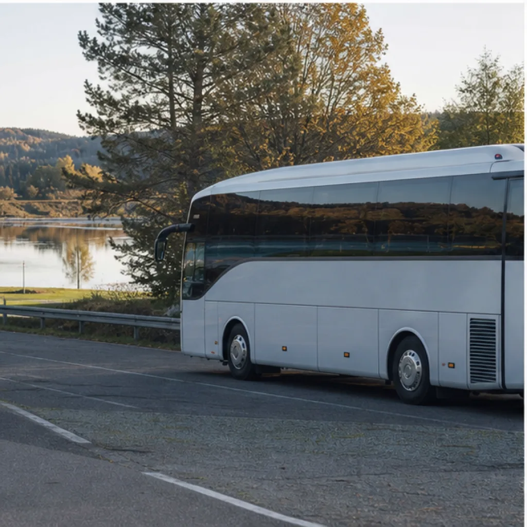 Chartrad turistbuss väntar vid en sjö inför en arrangerad gruppresa